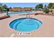 Community outdoor pool and spa includes lounge chairs and umbrellas at 5375 E La Campana Dr, Pahrump, NV 89061