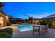 Stunning backyard with a pool, outdoor seating, and lush landscaping, creating an inviting atmosphere for outdoor enjoyment at 6192 Lautman Ridge Ct, Las Vegas, NV 89141