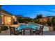 Beautiful backyard pool with a cozy seating area and well-maintained landscaping at 6192 Lautman Ridge Ct, Las Vegas, NV 89141