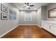 Bright bedroom featuring hardwood floors, a ceiling fan, and a window with plantation shutters at 6192 Lautman Ridge Ct, Las Vegas, NV 89141