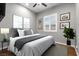 Well-lit bedroom with a neutral color scheme, plantation shutters, and modern decor at 6192 Lautman Ridge Ct, Las Vegas, NV 89141