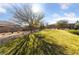 Community green space with mature trees, walking path, and bench at 6192 Lautman Ridge Ct, Las Vegas, NV 89141