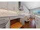 Kitchen with white cabinets, pull-out shelves, marble backsplash, and views to the outdoors at 6192 Lautman Ridge Ct, Las Vegas, NV 89141