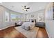 Spacious primary bedroom with hardwood floors, plantation shutters, ceiling fan, and sitting area at 6192 Lautman Ridge Ct, Las Vegas, NV 89141