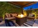 Inviting outdoor patio area featuring a comfortable seating arrangement around a modern fire pit at 6192 Lautman Ridge Ct, Las Vegas, NV 89141