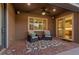Cozy covered patio with comfortable seating, stylish rug, and a glimpse of the well-appointed kitchen through the sliding glass door at 6192 Lautman Ridge Ct, Las Vegas, NV 89141