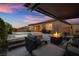 Cozy outdoor living space with a fireplace, comfortable seating, pool and spa offering relaxation and entertainment at 6192 Lautman Ridge Ct, Las Vegas, NV 89141