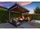 Charming outdoor pergola with comfortable seating, a fire pit, creating a cozy and inviting backyard retreat at 6192 Lautman Ridge Ct, Las Vegas, NV 89141