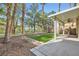 An outdoor patio with lush green lawn and mature trees offers serene views at 62 Myrtle Springs Ct, Las Vegas, NV 89148