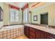 Bright bathroom featuring a double vanity, soaking tub, and plantation shutters at 62 Myrtle Springs Ct, Las Vegas, NV 89148