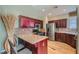 A well lit kitchen with custom cabinetry, a breakfast bar, and stainless appliances at 62 Myrtle Springs Ct, Las Vegas, NV 89148