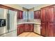 A spacious kitchen with cherry cabinets, stainless appliances and tiled backsplash at 62 Myrtle Springs Ct, Las Vegas, NV 89148