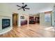 Open concept living room boasts a fireplace, hardwood floors, built-in bar and seamless kitchen access at 62 Myrtle Springs Ct, Las Vegas, NV 89148