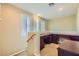 Loft area featuring built-in desks and cabinets with natural light from the bright window at 62 Myrtle Springs Ct, Las Vegas, NV 89148
