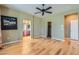 This home features a spacious main bedroom with hardwood floors, a ceiling fan, and access to the walk-in closet and ensuite bathroom at 62 Myrtle Springs Ct, Las Vegas, NV 89148
