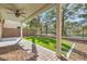 Covered patio area with brick flooring, with views of the landscaped backyard at 62 Myrtle Springs Ct, Las Vegas, NV 89148