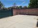 A view of the back yard with concrete pad and brick wall at 6215 Darby Ave, Las Vegas, NV 89146
