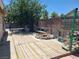 Spacious backyard deck featuring a rock-lined fire pit and wooden benches for outdoor entertaining at 6215 Darby Ave, Las Vegas, NV 89146