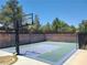 Backyard basketball court with a full-sized hoop, surrounded by a brick fence and mature trees at 6215 Darby Ave, Las Vegas, NV 89146