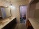 Bathroom features a double vanity with a large mirror and tiled walls at 6215 Darby Ave, Las Vegas, NV 89146