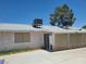 Back exterior of a home with vintage air conditioning units and sun screens on a bright sunny day at 6215 Darby Ave, Las Vegas, NV 89146
