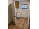 Utility room with a window, sink, cabinet, and tile flooring needing some cleanup and maintenance at 6215 Darby Ave, Las Vegas, NV 89146