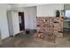 Living room with a brick fireplace and an open wardrobe at 6215 Darby Ave, Las Vegas, NV 89146