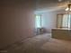 Spacious living room featuring natural light, classic light fixture, and a built-in desk at 6215 Darby Ave, Las Vegas, NV 89146