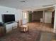 Spacious living room with tiled flooring, neutral walls, and bright, natural light at 6215 Darby Ave, Las Vegas, NV 89146