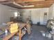 Interior of a messy shed with exposed beams, shelving, and various storage items at 6215 Darby Ave, Las Vegas, NV 89146