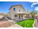 Backyard view of a house with a covered patio and artificial grass at 6420 Rosemount Ave, Las Vegas, NV 89156