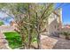 An inviting backyard featuring a well-maintained lawn and partial view of the home's exterior at 6420 Rosemount Ave, Las Vegas, NV 89156