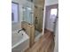 Modern bathroom featuring a glass-enclosed shower, separate tub, and sleek fixtures at 6420 Rosemount Ave, Las Vegas, NV 89156