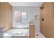 Relaxing bathroom featuring a soaking tub, separate shower with modern fixtures, and stylish tile work at 6420 Rosemount Ave, Las Vegas, NV 89156