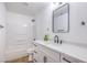 Bright bathroom featuring a shower-tub, vanity, framed mirror, and white subway tile at 6420 Rosemount Ave, Las Vegas, NV 89156