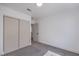 Bedroom with neutral carpet, white walls, closet with sliding doors, and a window at 6420 Rosemount Ave, Las Vegas, NV 89156