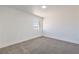 Bedroom with neutral carpet, white walls, and a bright window at 6420 Rosemount Ave, Las Vegas, NV 89156