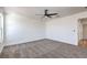 A carpeted bedroom is freshly painted and features a modern ceiling fan and ample natural light at 6420 Rosemount Ave, Las Vegas, NV 89156