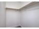 Empty walk-in closet with a built-in wooden shelf and rod at 6420 Rosemount Ave, Las Vegas, NV 89156