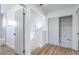 Bright hallway with wood-look flooring and access to various rooms and the stairway at 6420 Rosemount Ave, Las Vegas, NV 89156