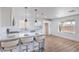 Modern kitchen with stainless appliances, white cabinets, and breakfast bar at 6420 Rosemount Ave, Las Vegas, NV 89156