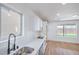 Bright kitchen with stainless steel sink and wood-look floors at 6420 Rosemount Ave, Las Vegas, NV 89156