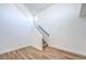 Interior staircase with wood-look floors and natural light from a high window at 6420 Rosemount Ave, Las Vegas, NV 89156
