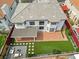 Aerial view of the home showing backyard with patio, fire pit, and landscaped lawn at 6639 Tranquil Seas Ct, Las Vegas, NV 89139