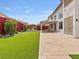 Large backyard featuring a patio, dining area, fire pit, and lush green space at 6639 Tranquil Seas Ct, Las Vegas, NV 89139