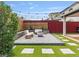 Beautiful backyard patio with outdoor seating, fire pit, and manicured landscaping at 6639 Tranquil Seas Ct, Las Vegas, NV 89139