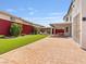 Extensive backyard with brick patio, fire pit, dining area, and well-manicured lawn at 6639 Tranquil Seas Ct, Las Vegas, NV 89139