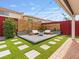 Inviting backyard features a modern patio with a fire pit and stylish seating, perfect for outdoor entertaining at 6639 Tranquil Seas Ct, Las Vegas, NV 89139