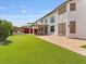 Spacious backyard with patio, dining area, fire pit, and artificial grass at 6639 Tranquil Seas Ct, Las Vegas, NV 89139