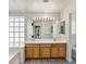 Bathroom featuring double sinks, large mirror and decorative window, providing a functional and stylish space at 6639 Tranquil Seas Ct, Las Vegas, NV 89139